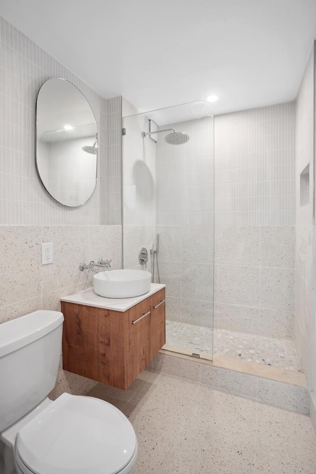 1330 5th Ave Unit 4M, New York City, NY 10026 - bathroom with tile walls, walk in shower, vanity, toilet, and recessed lighting