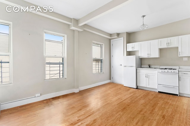 kitchen featuring white appliances, light wood-style floors, white cabinets, plenty of natural light, and beam ceiling