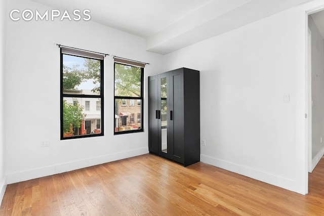 unfurnished room featuring light wood-style flooring and baseboards