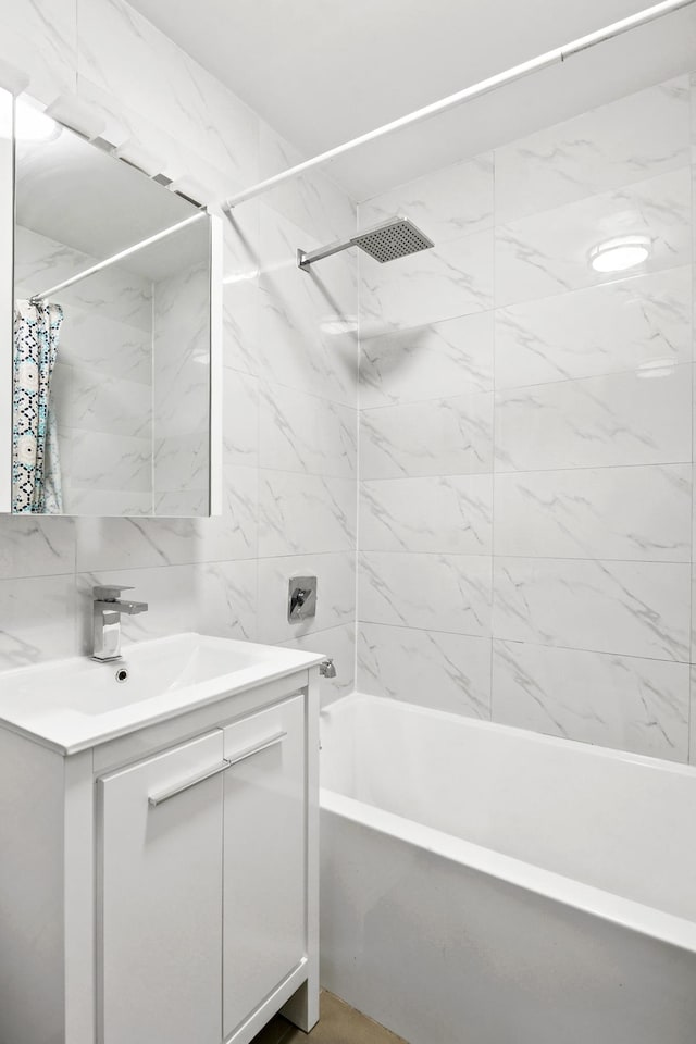 full bath featuring shower / tub combo, vanity, and tile walls