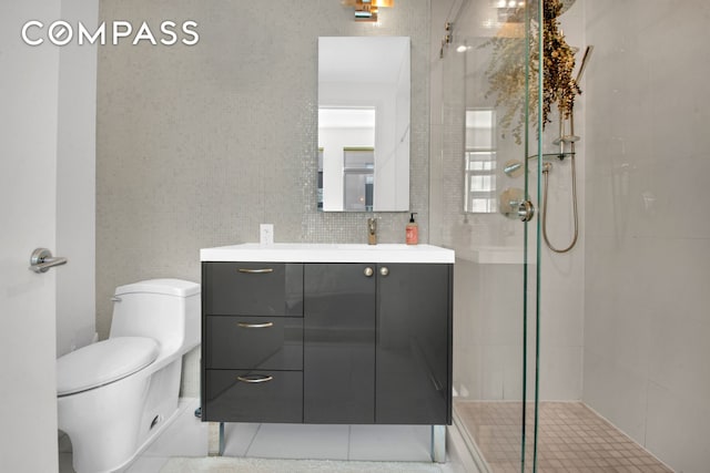 bathroom featuring tiled shower, tile walls, vanity, and toilet