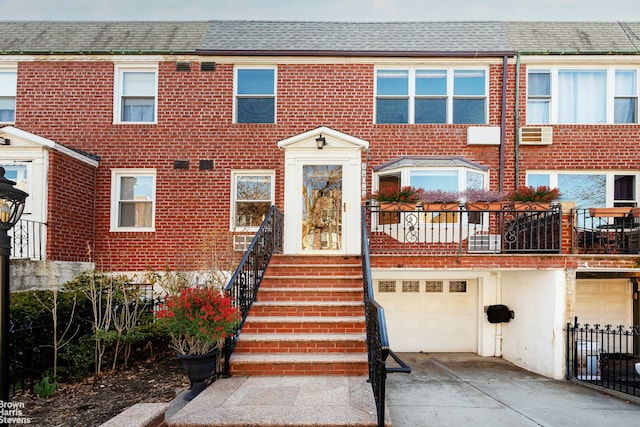 26-08 24th Ave, New York City, NY 11102 - view of property with driveway, a garage, roof with shingles, and brick siding