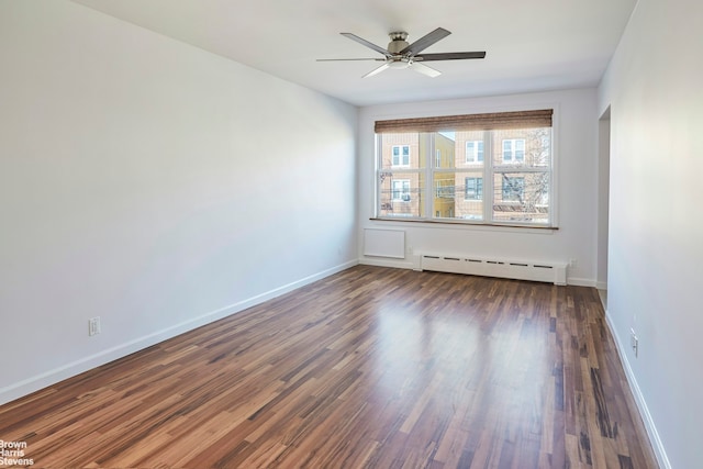 26-08 24th Ave, New York City, NY 11102 - unfurnished room with a baseboard radiator, dark wood-style flooring, a ceiling fan, and baseboards
