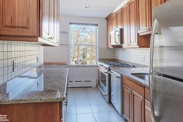 26-08 24th Ave, New York City, NY 11102 - kitchen featuring appliances with stainless steel finishes, baseboard heating, backsplash, light tile patterned floors, and recessed lighting