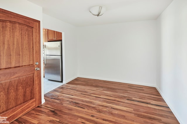26-08 24th Ave, New York City, NY 11102 - unfurnished dining area with wood finished floors and baseboards