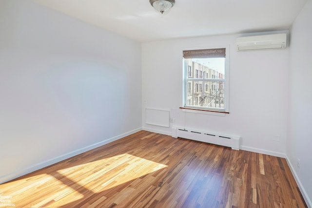 26-08 24th Ave, New York City, NY 11102 - empty room with a baseboard heating unit, a wall unit AC, wood finished floors, and baseboards