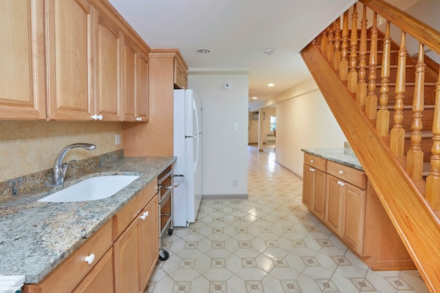 26-08 24th Ave, New York City, NY 11102 - kitchen featuring a sink, freestanding refrigerator, light flooring, light stone countertops, and recessed lighting