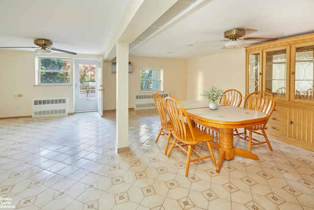 26-08 24th Ave, New York City, NY 11102 - dining room featuring radiator heating unit, ceiling fan, an AC wall unit, and baseboards