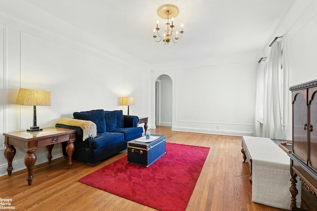 45-14 43rd St Unit 2D, New York City, NY 11104 - living area with arched walkways, hardwood / wood-style flooring, and a chandelier