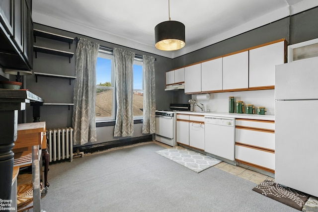45-14 43rd St Unit 2D, New York City, NY 11104 - kitchen with white appliances, under cabinet range hood, light countertops, white cabinetry, and radiator heating unit