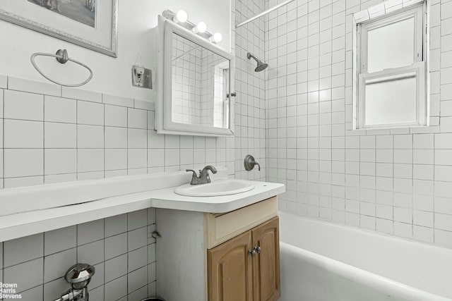 45-14 43rd St Unit 2D, New York City, NY 11104 - bathroom featuring tile walls, vanity, bathing tub / shower combination, and backsplash