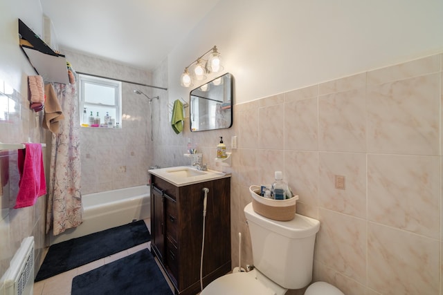 bathroom featuring tile walls, toilet, shower / tub combo, tile patterned floors, and vanity