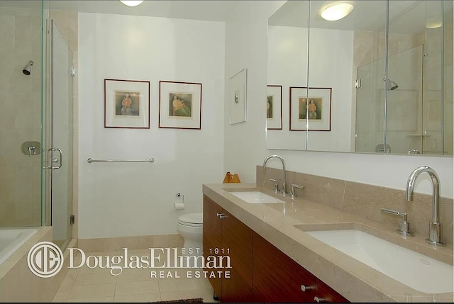 30 W St Unit 20F, New York City, NY 10004 - full bathroom featuring a shower stall, double vanity, tile patterned flooring, toilet, and a bath