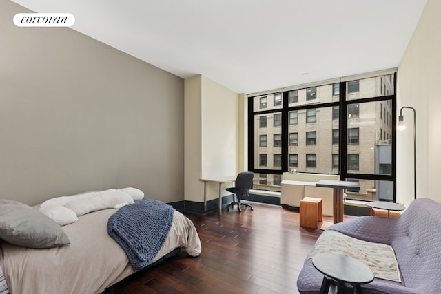 40 Broad St Unit 18C, New York City, NY 10004 - bedroom featuring wood finished floors, floor to ceiling windows, and multiple windows