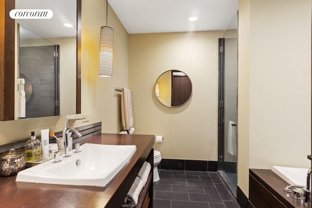 40 Broad St Unit 18C, New York City, NY 10004 - bathroom featuring vanity, a stall shower, tile patterned flooring, toilet, and baseboards
