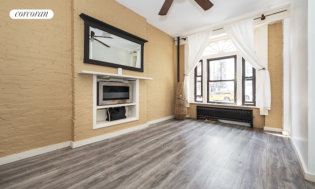 107 W 106th St Unit A, New York City, NY 10025 - unfurnished living room featuring radiator heating unit, a ceiling fan, wood finished floors, and baseboards