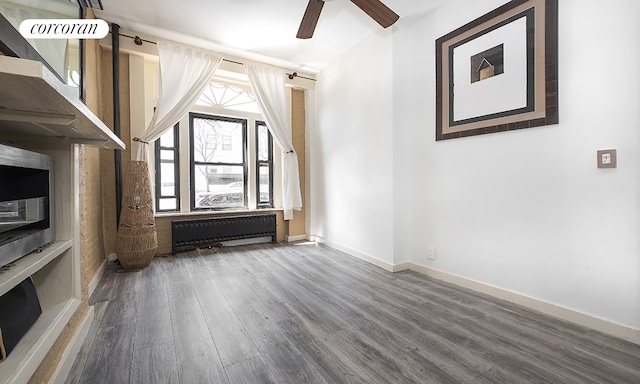 107 W 106th St Unit A, New York City, NY 10025 - unfurnished living room featuring radiator, ceiling fan, wood finished floors, and baseboards