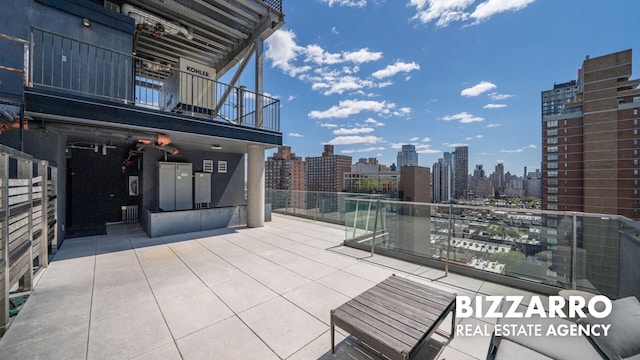302 E 96th St Unit 502, New York City, NY 10128 - view of patio featuring a balcony and a view of skyline