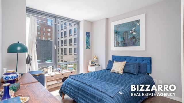 302 E 96th St Unit 502, New York City, NY 10128 - bedroom featuring wood finished floors and multiple windows