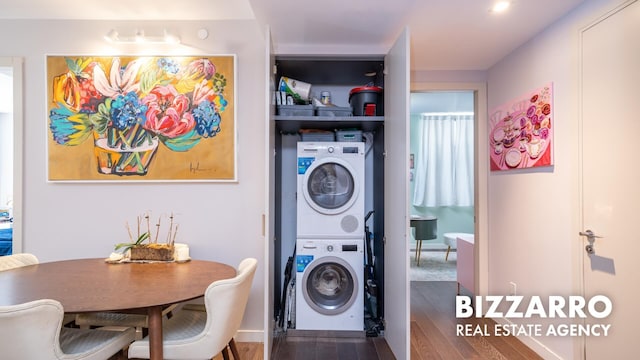 302 E 96th St Unit 502, New York City, NY 10128 - washroom with stacked washer / drying machine and wood finished floors