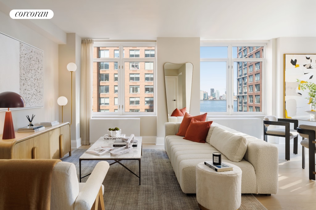 210 Warren St Unit 9I, New York City, NY 10282 - living area with healthy amount of natural light and wood finished floors