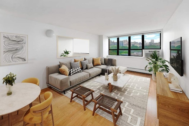 living room featuring light wood finished floors and a baseboard radiator