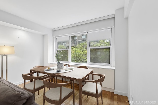 310 E 49th St Unit 4-D, New York City, NY 10017 - dining space with light wood-style floors and baseboards