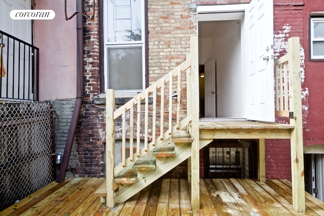view of exterior entry featuring brick siding