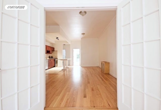 unfurnished living room featuring light wood-style floors and baseboards