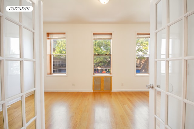 unfurnished room featuring wood finished floors and baseboards