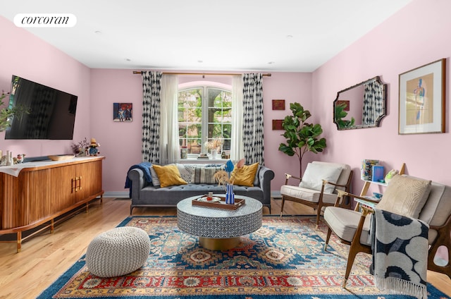 living room with light wood-type flooring and baseboards