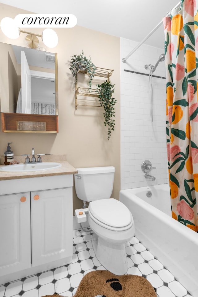 bathroom with shower / bathtub combination with curtain, toilet, vanity, and tile patterned floors