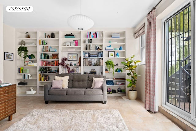 living area with light tile patterned floors and built in features