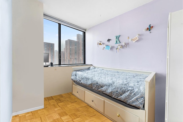 245 E 93rd St Unit 22C, New York City, NY 10128 - bedroom featuring a view of city and baseboards