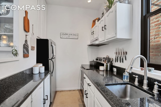 255 W 95th St Unit 6D, New York City, NY 10025 - kitchen featuring stainless steel appliances, under cabinet range hood, white cabinetry, and dark stone counters