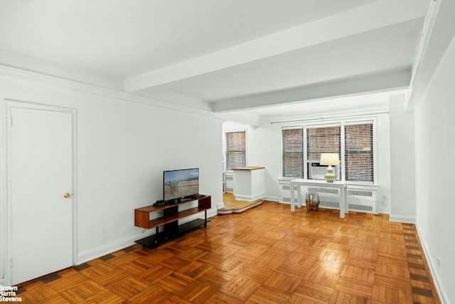 123 E 37th St Unit 6B, New York City, NY 10016 - living area featuring baseboards, beamed ceiling, and radiator