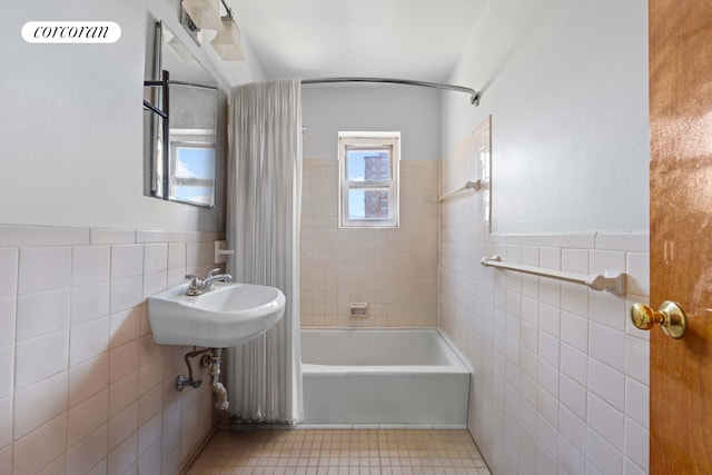 3240 Riverdale Ave Unit 6J, New York City, NY 10463 - full bath with tile walls, tub / shower combination, tile patterned floors, and wainscoting