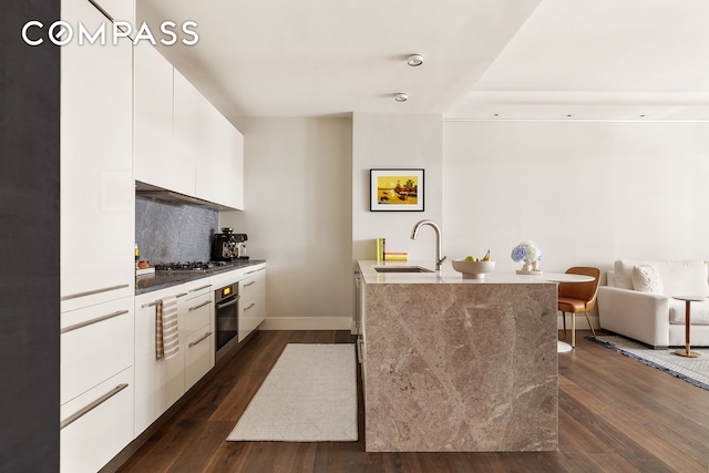 4 W 21st St Unit 2D, New York City, NY 10010 - kitchen featuring appliances with stainless steel finishes, modern cabinets, white cabinets, and dark wood finished floors