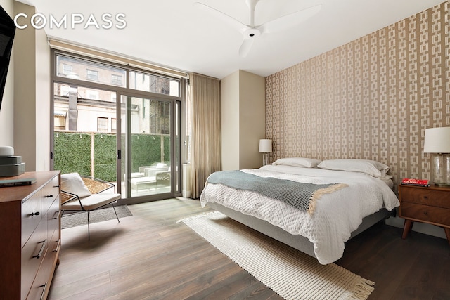 4 W 21st St Unit 2D, New York City, NY 10010 - bedroom featuring wallpapered walls, access to exterior, expansive windows, light wood-style flooring, and an accent wall