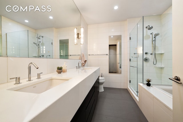 4 W 21st St Unit 2D, New York City, NY 10010 - full bathroom featuring a stall shower, a bath, tile walls, double vanity, and recessed lighting