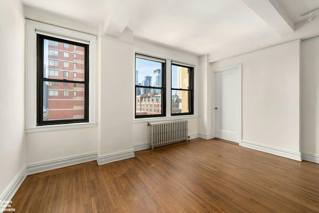 457 W 57th St Unit 1016, New York City, NY 10019 - spare room with radiator heating unit, wood finished floors, and baseboards