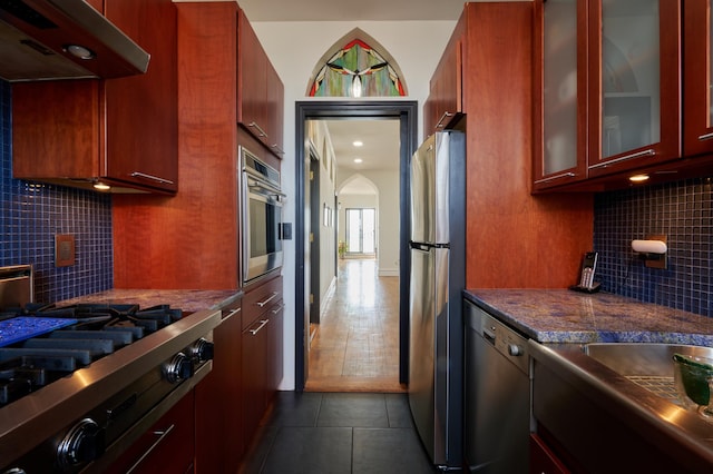 75 Livingston St Unit 28-A, New York City, NY 11201 - kitchen featuring stainless steel appliances, under cabinet range hood, dark tile patterned floors, and backsplash