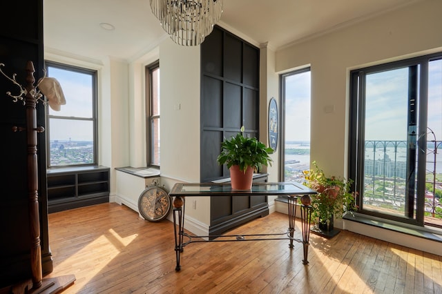 75 Livingston St Unit 28-A, New York City, NY 11201 - corridor featuring crown molding, light wood-type flooring, and a chandelier