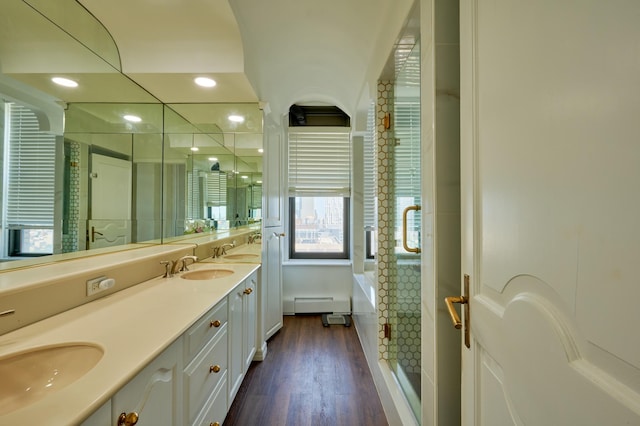 75 Livingston St Unit 28-A, New York City, NY 11201 - bathroom featuring double vanity, a stall shower, a bath, wood finished floors, and baseboard heating
