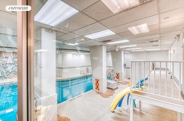 500 E 83rd St Unit 3D, New York City, NY 10028 - playroom with carpet floors and a paneled ceiling