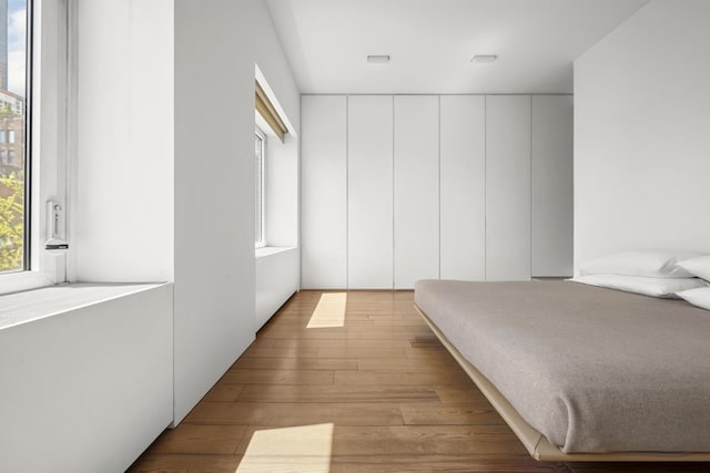 455 E 51st St Unit 5F, New York City, NY 10022 - bedroom featuring hardwood / wood-style flooring