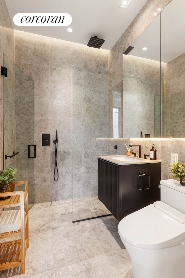 bathroom featuring tile walls, walk in shower, vanity, toilet, and recessed lighting