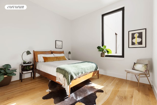 bedroom featuring light wood-style flooring and baseboards