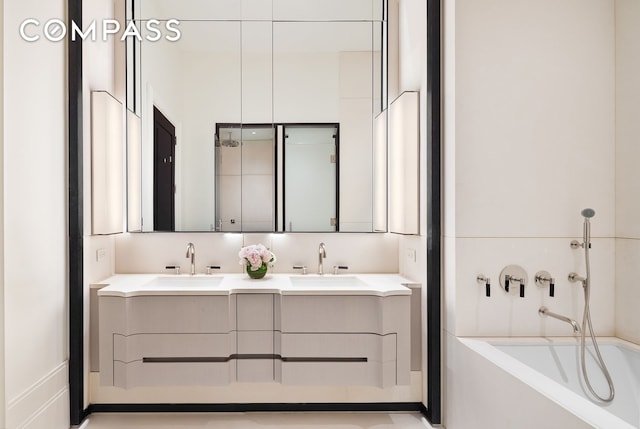 bathroom with a bathtub and double vanity