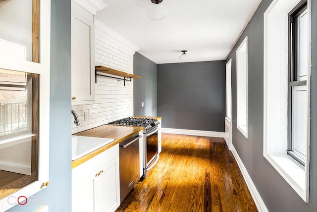 35-15 84th St Unit 2E, New York City, NY 11372 - kitchen with open shelves, a sink, stainless steel appliances, tasteful backsplash, and dark wood-type flooring